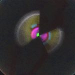 A bowtie-shaped spectral of lights representing the universe. The center is bright green, then radiates the hot pink, magenta, yellow, and then white and finally gray.