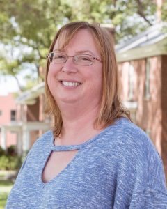 A head shot of Shelly Minteer, a white woman with blond shoulder-length hair and wire-rimmed glasses.