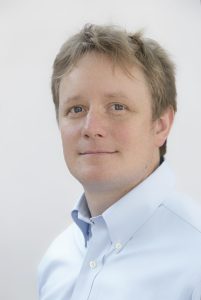 Headshot of a white male wearing a collared white shirt