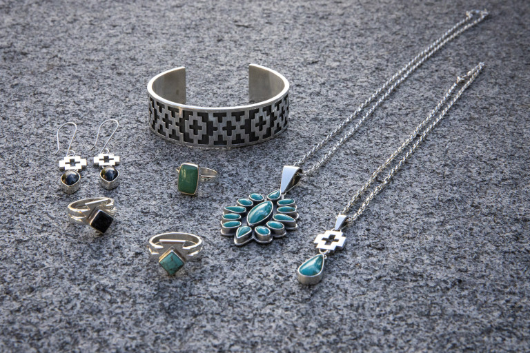 A collection of bracelets, rings and earrings on display.