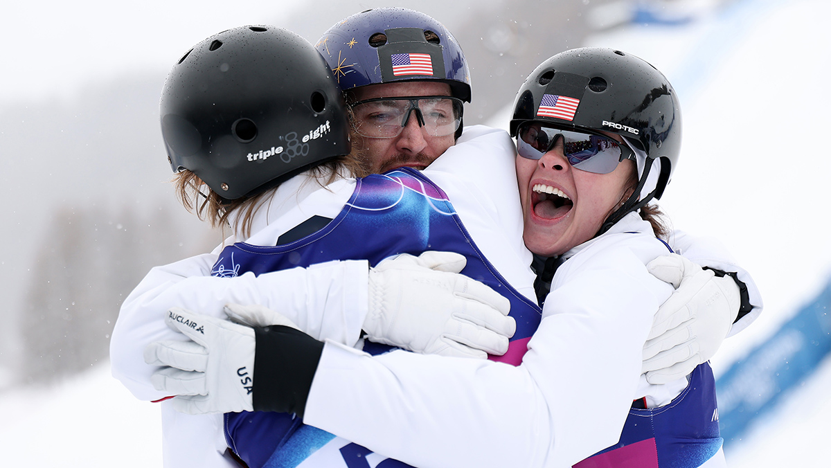 LIVIGNO, ITALY - FEBRUARY 21: Gold medalists Connor Curran of Team United States, Christopher Lillis of Team United States and Kaila Kuhn of Team United States celebrate their victory following the Mixed Team Aerials Final on day fifteen of the Milano Cortina 2026 Winter Olympic games at Livigno Air Park on February 21, 2026 in Livigno, Italy. (Photo by Michael Reaves/Getty Images)